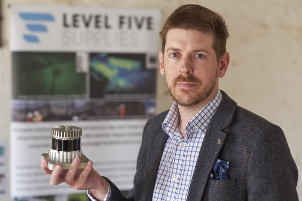 Alex Lawrence Berkeley CEO Level Five Supplies holding an Ouster LiDAR unit